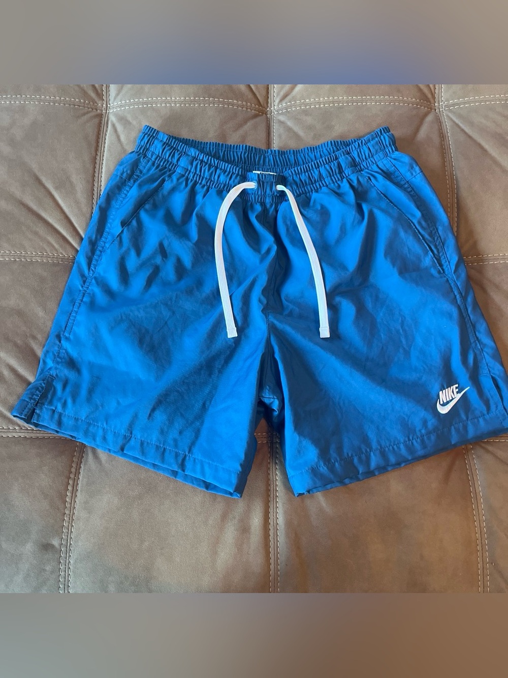 Nike Blue Athletic Shorts with White Drawstring and Swoosh